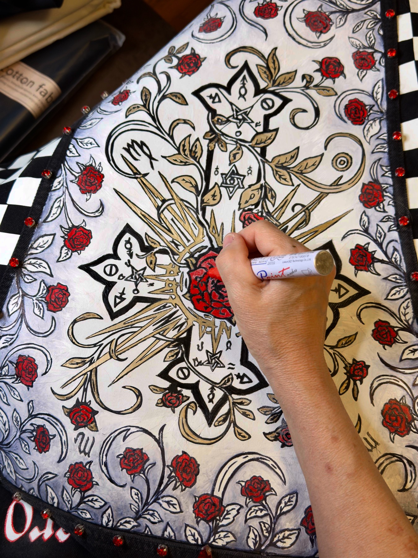 Debbi hand-painting the back panel of the jacket in the atelier